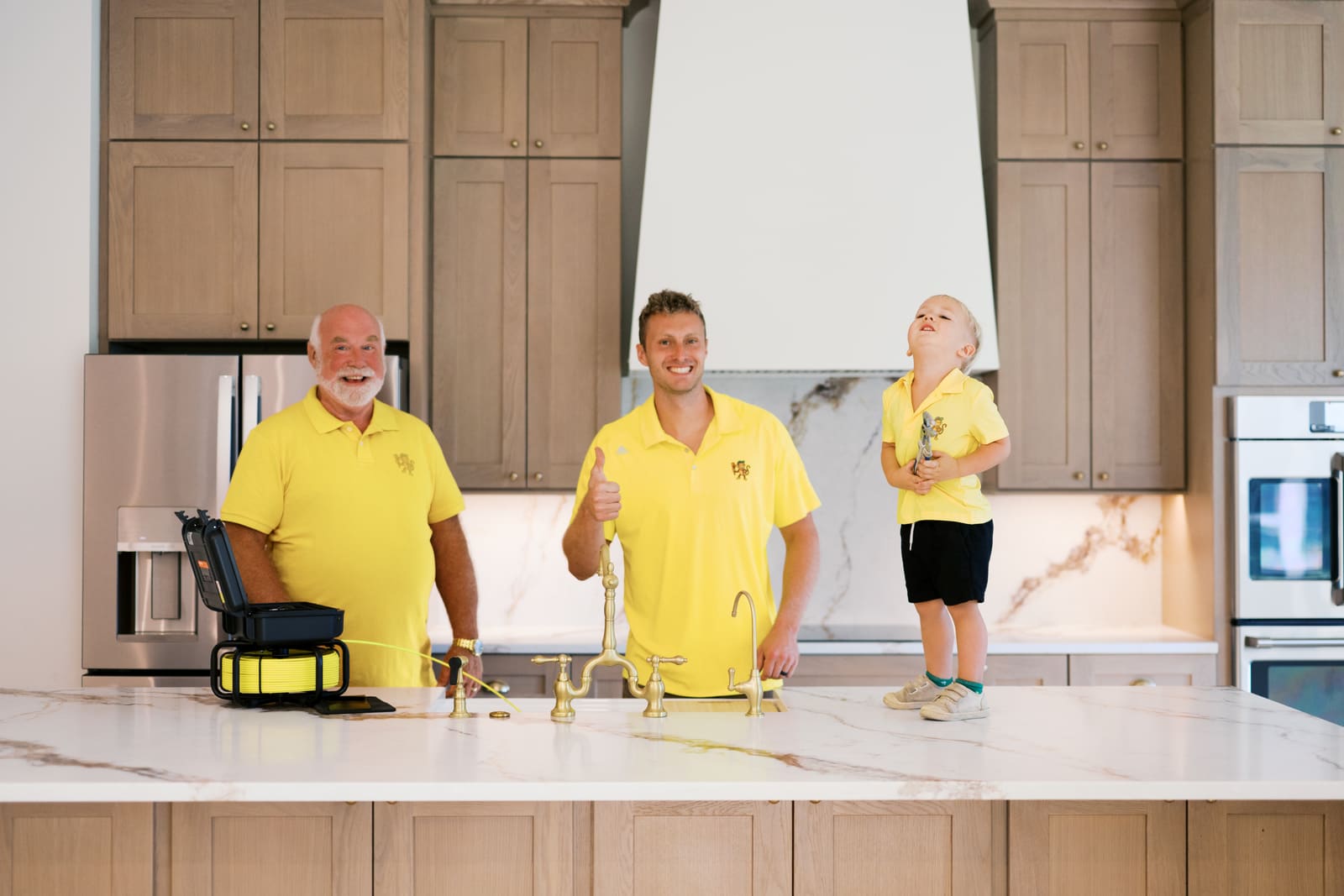 Josh and his son in a kitchen after finishing a job