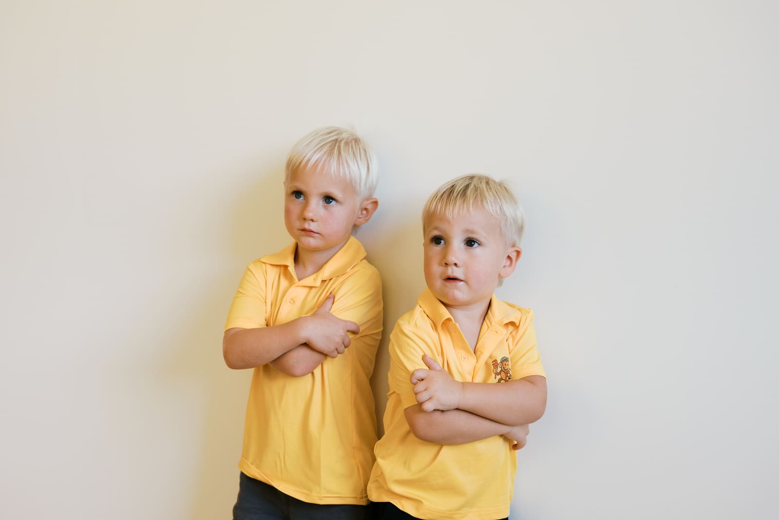 Callahan and Lewis, future plumbers, wearing Rapid Water Heater yellow shirts with arms crossed