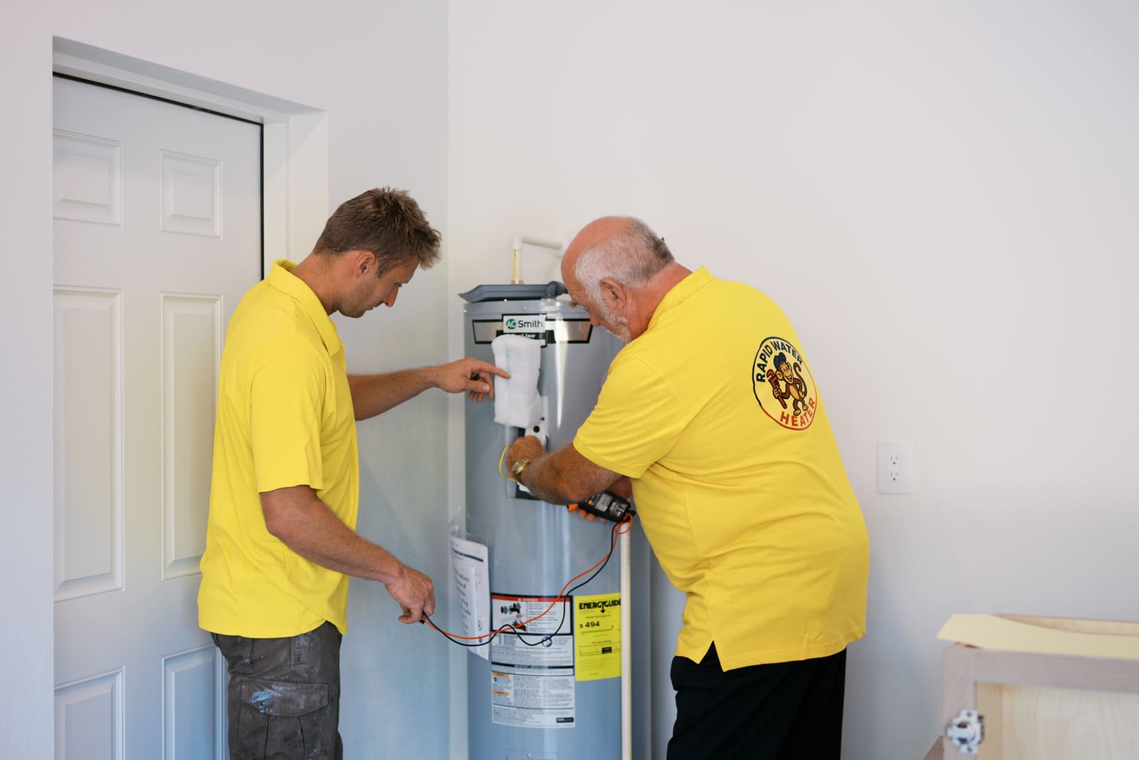 Josh and Pat installing a tank water heater