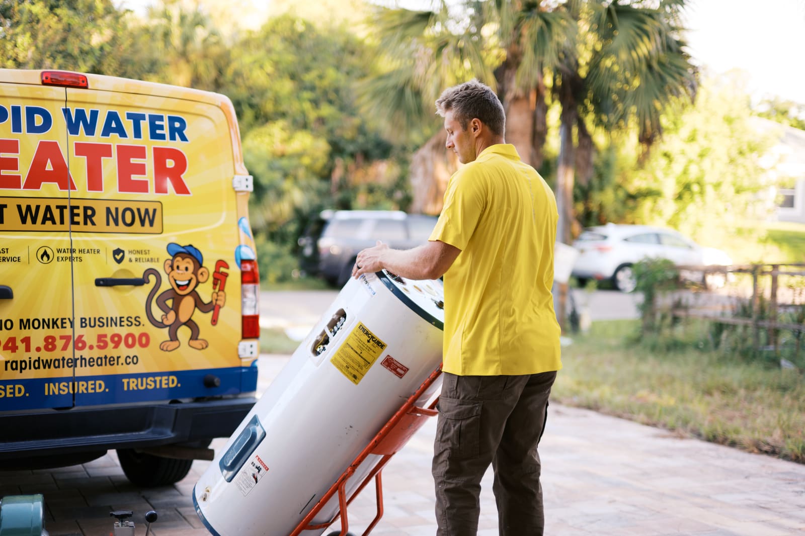 Josh wheeling a new water heater to a customer's home