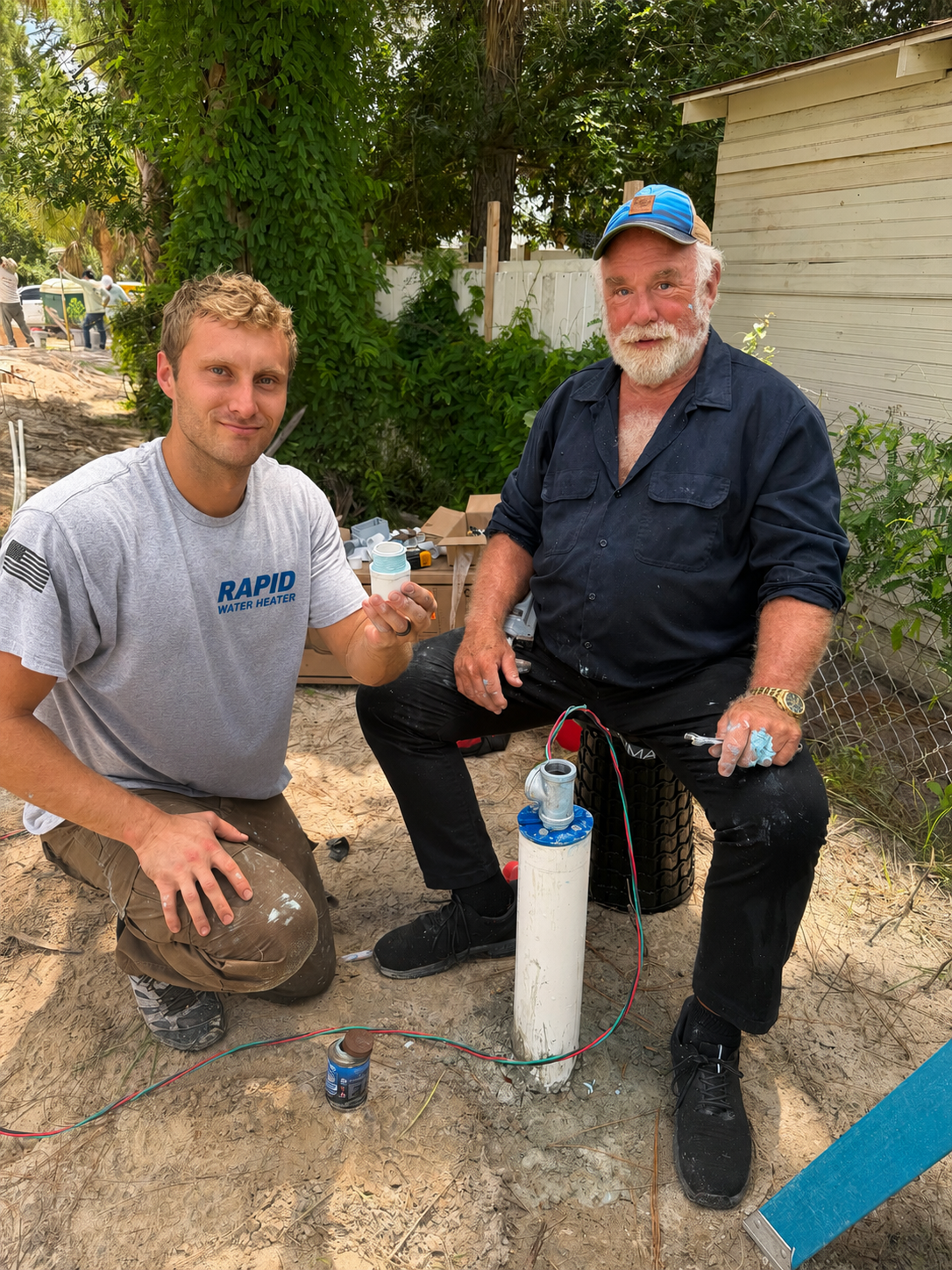 Josh and Pat of Rapid Water Heater on an outdoor plumbing job